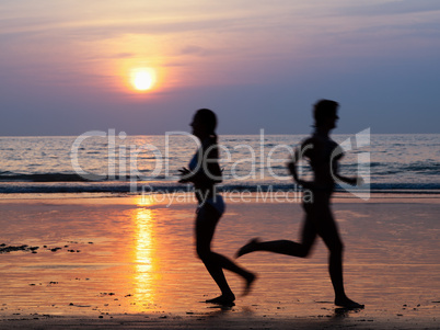 Girls at the beach running by the ocean at sunset, Blurred Motion