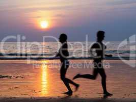 Girls at the beach running by the ocean at sunset, Blurred Motion