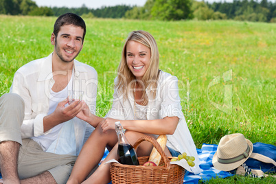 Picnic young happy couple celebrating with wine