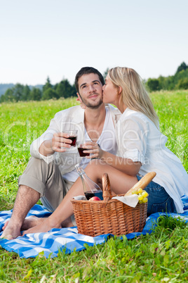 Picnic young happy couple celebrating with wine