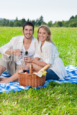 Picnic young happy couple celebrating with wine