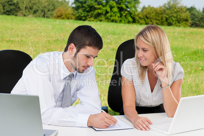 Business colleagues in nature with laptop smile