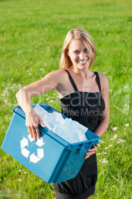 Recycling paper box businesswoman in sunny meadow