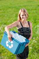 Recycling paper box businesswoman in sunny meadow