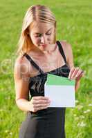 Surprise envelope young businesswoman sunny meadow