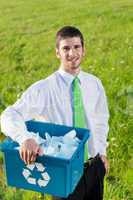 Recycling paper box businessman in sunny meadow