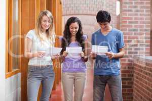 Students reading a piece of paper