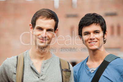 Smiling male students posing