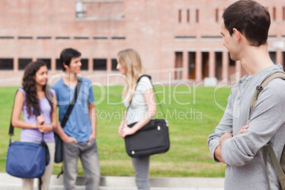 Student looking at his classmates talking
