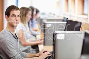 Male student posing with a computer
