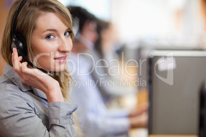 Close up of a blonde operator posing with a headset