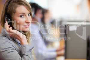 Close up of a blonde operator posing with a headset