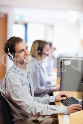 Portrait of a smiling customer assistant using a headset