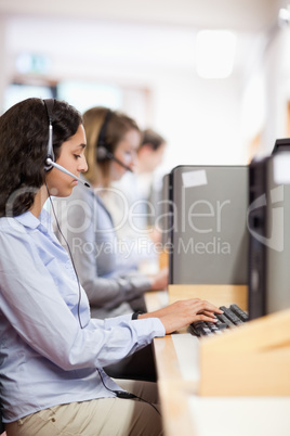 Portrait of a customer assistant working with a computer