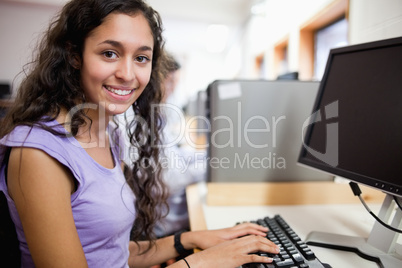 Cute smiling student with a computer