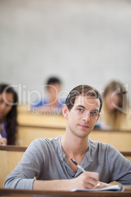 Portrait of students taking notes in an amphitheater