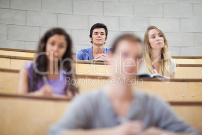 Smiling students listening during a lecture