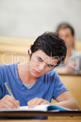 Portrait of a student taking notes