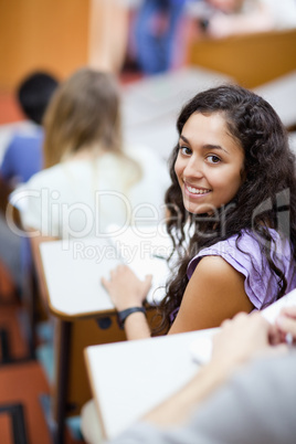 Portrait of a smiling student being distracted