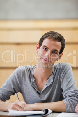 Portrait of a male student holding a pen