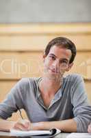 Portrait of a male student holding a pen