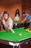 Portrait of a student woman playing snooker