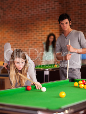 Portrait of friends playing snooker