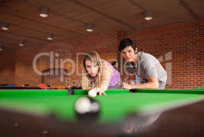 Man teaching pool to his girlfriend