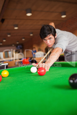 Portrait of a student playing pool