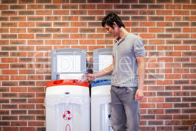 Young man recycling