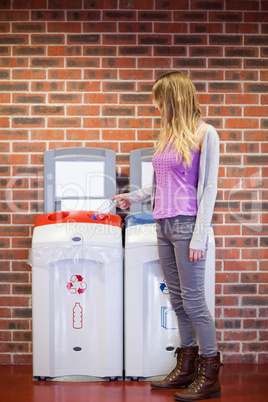 Portrait of a cute student recycling