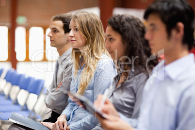 Business people listening and taking notes