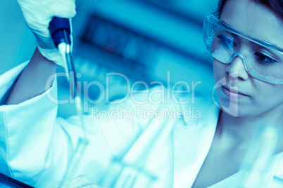 Science student dropping liquid in a test tube