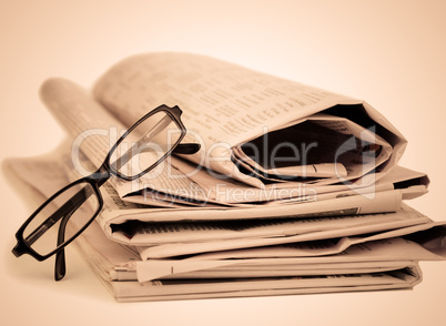 Newspapers and black glasses