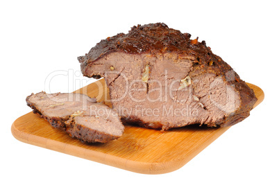 Roast beef on a wooden board