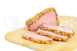Piece of a ham with spices on a wooden board