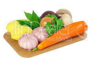Board with potatoes, garlic, carrots, mushrooms