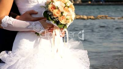 Bride and groom holding a bouquet