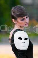 Caucasian girl with closed eyes and white mask on shoulder
