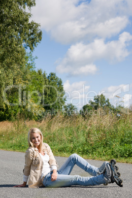 Inline skates young woman sitting asphalt road