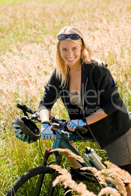 Mountain biking young woman sportive sunny meadows