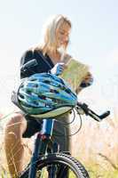 Mountain biking young woman search in map