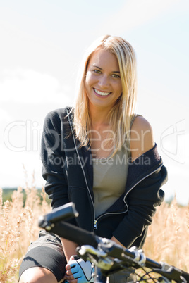 Mountain biking young woman sportive sunny meadows