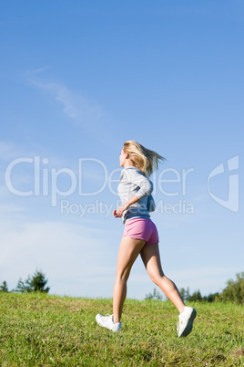 Jogging young sportive woman meadows sunny day