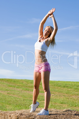 Stretching sport fit woman summer blue sky