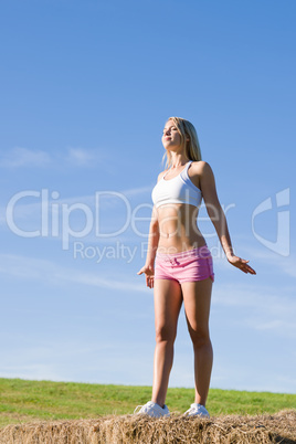 Stretching sport fit woman summer blue sky