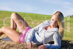 Sportive young woman relax on hay bales