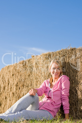 Sportive young woman relax by bales sunset