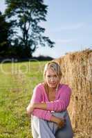 Sportive young woman relax by bales sunset