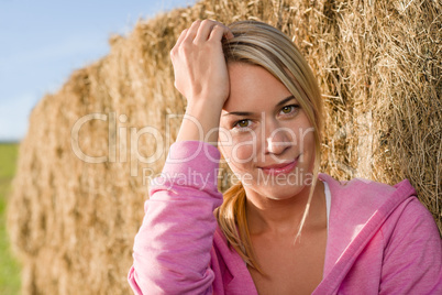 Sportive young woman relax by bales sunset